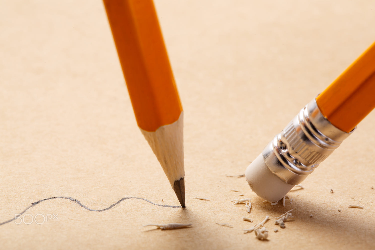 pencil draws a straight line on brown paper and pencil rubber eraser removing stripe. Business Breaking concept. Education. Art. Office supplies.